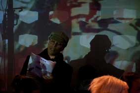 warren rosenzweig reading #WB: quoting Walter Benjamin, Paris, die Hauptstadt des XIX. Jahrhunderts during the interactive performance in the jewish theater of austria on October 7, 2010; sari projection; photographer: lisa sperber