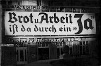 photo: ÖNB, © VGA, "Anschluss" of Austria to the "German Reich"; the photo shows a huge board to the façade of a house, 1938